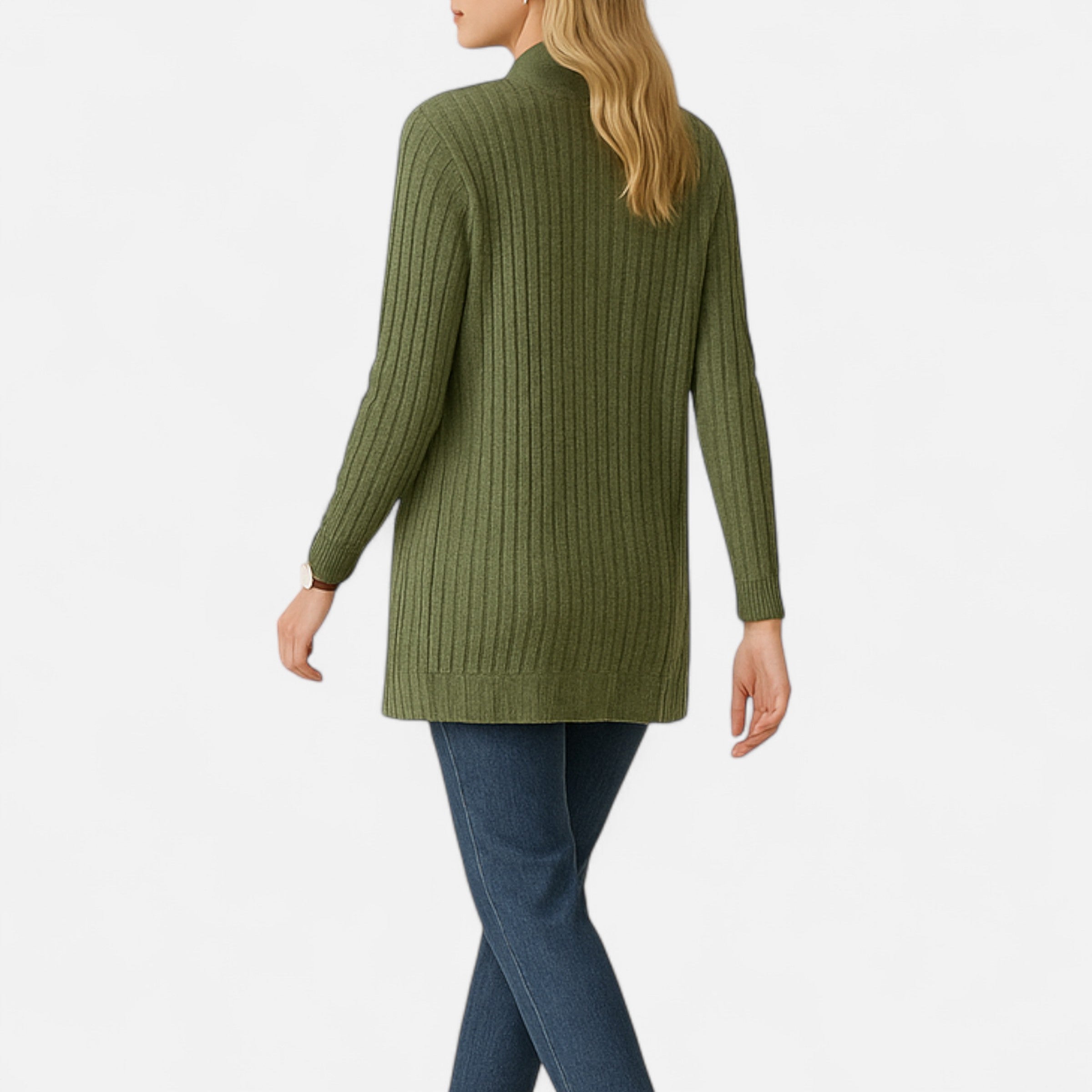 Person wearing a green ribbed sweater and blue jeans on a white background
