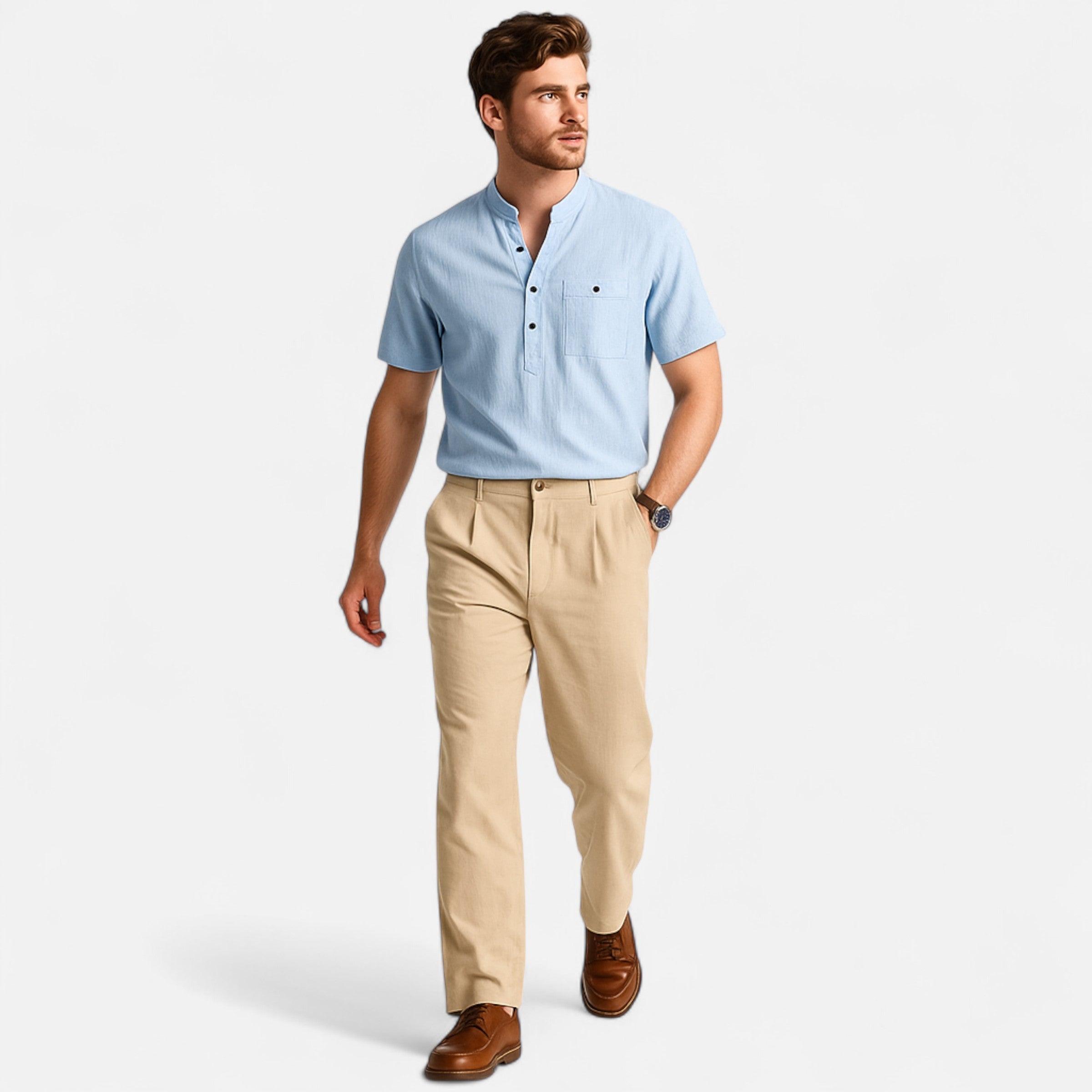Man wearing a light blue shirt and beige pants on a white background