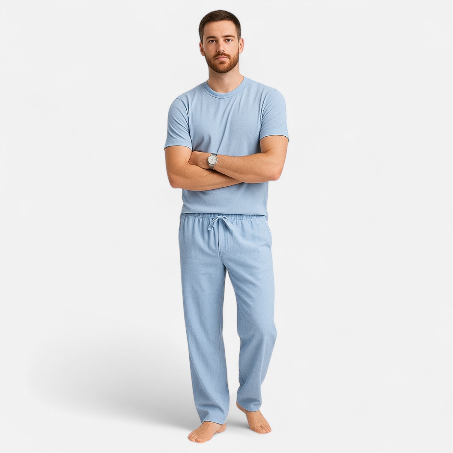 Man wearing a light blue pajama set on a white background