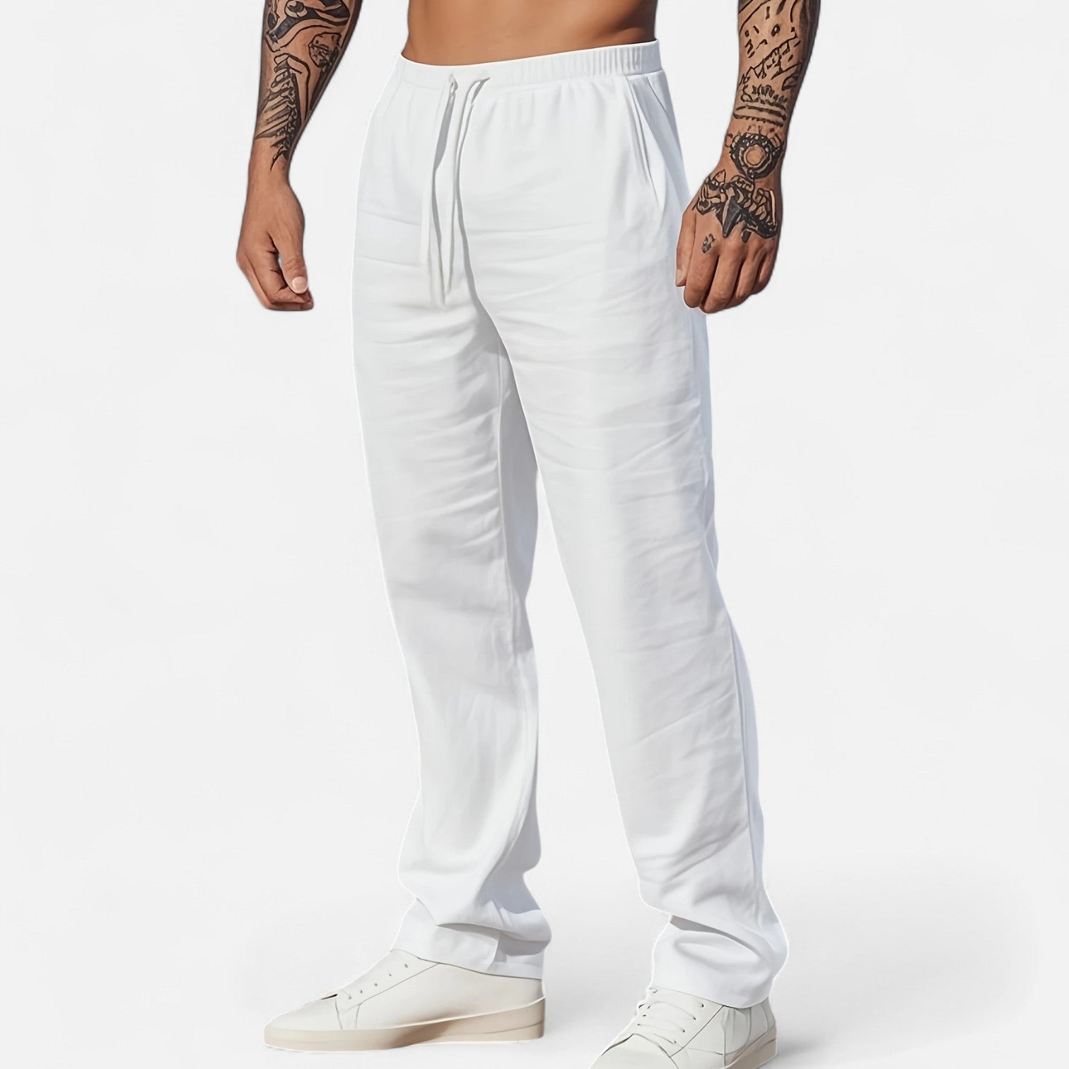 White sweatpants worn by a person on a white background