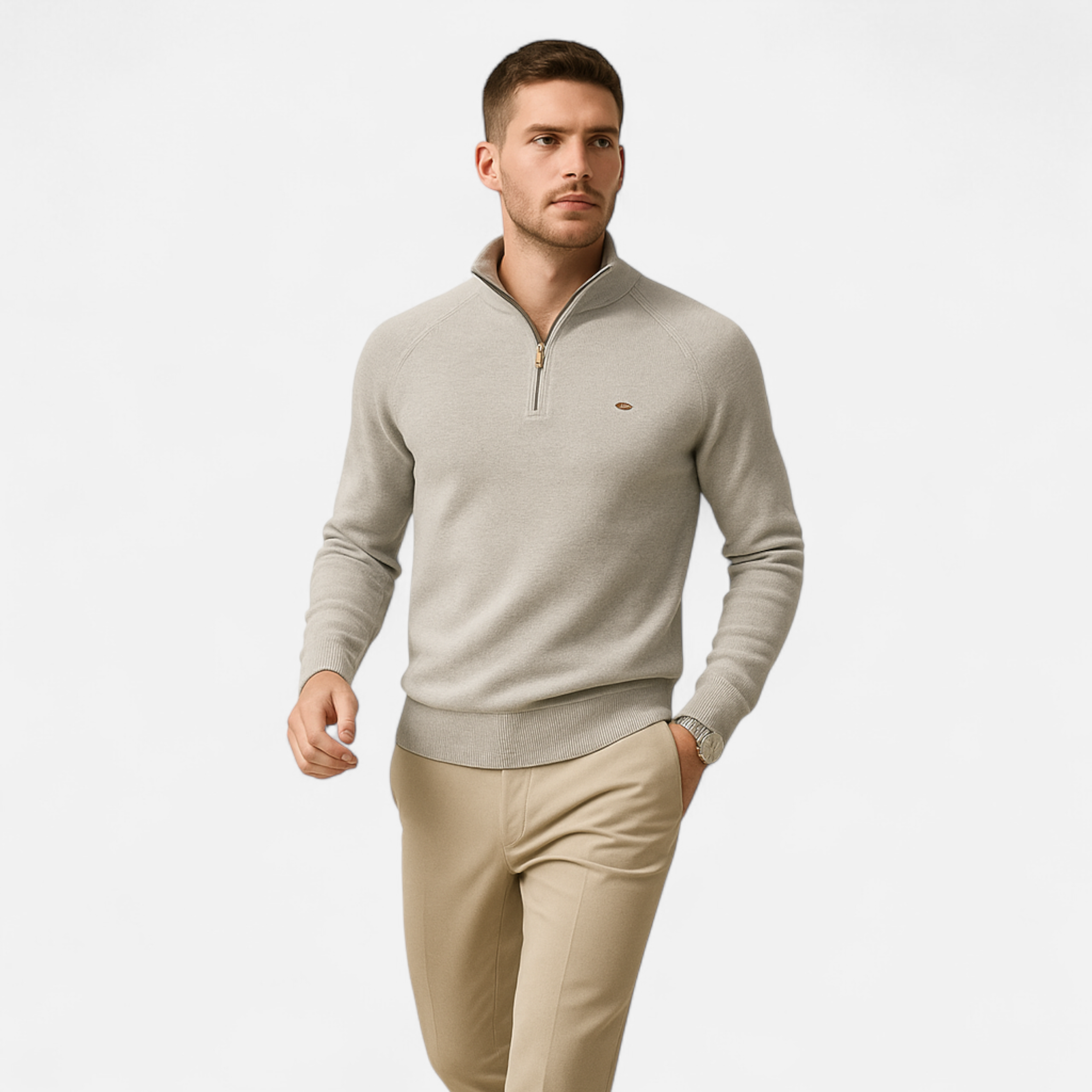 Man wearing a beige sweater and pants on a white background