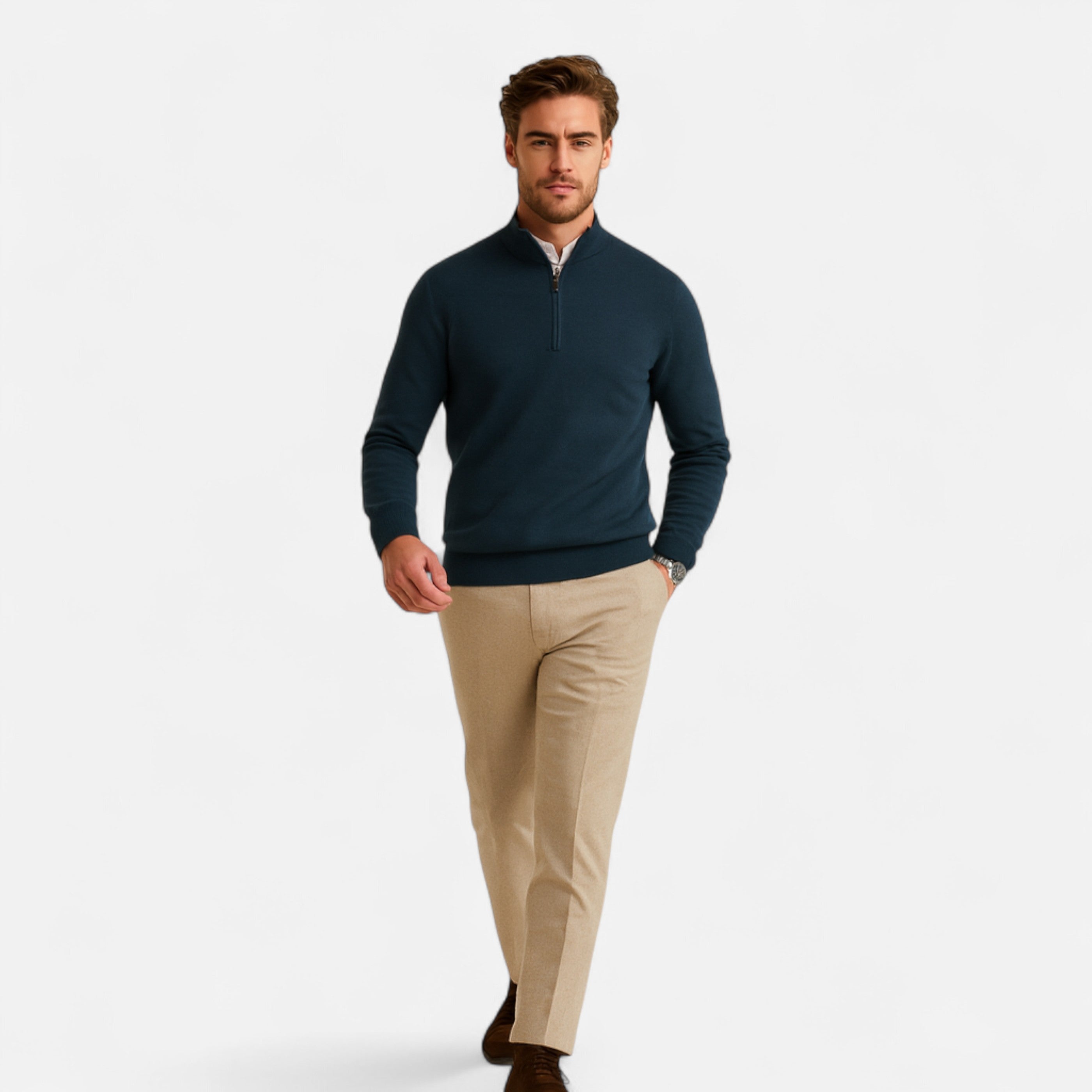 Man wearing a navy sweater and beige pants on a white background