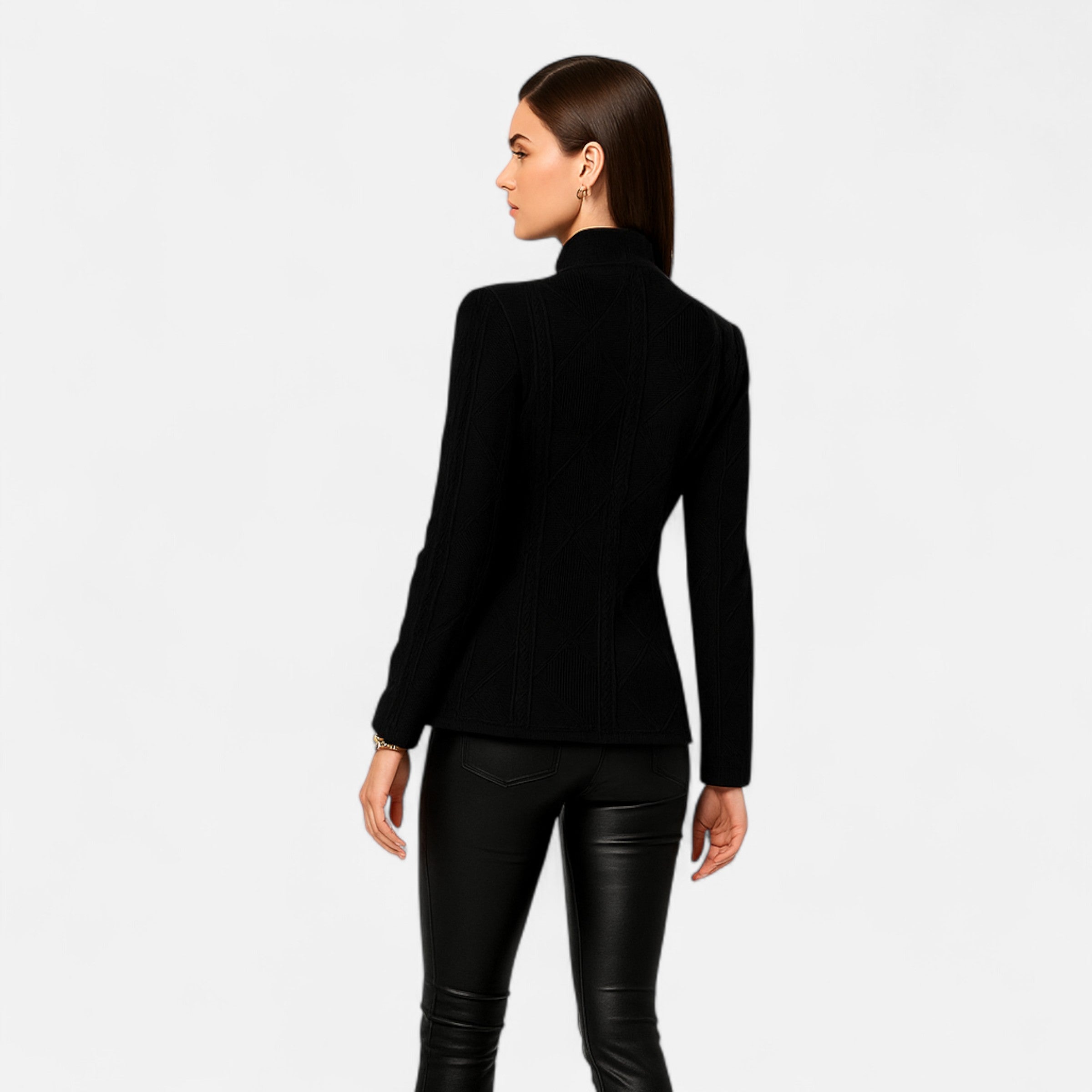 Woman wearing a black long-sleeve top and black pants on a white background