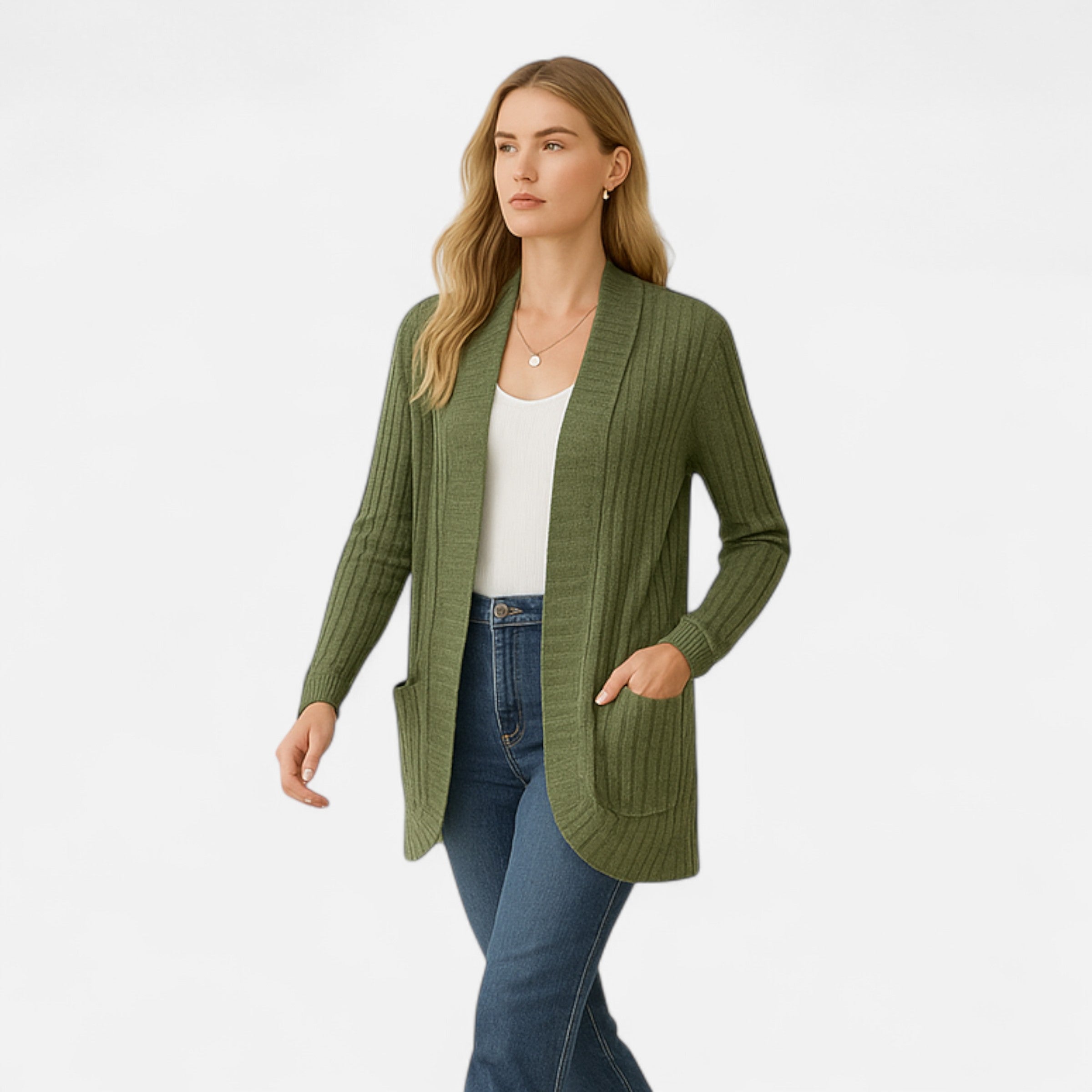 Woman wearing a green cardigan over a white shirt and blue jeans on a white background