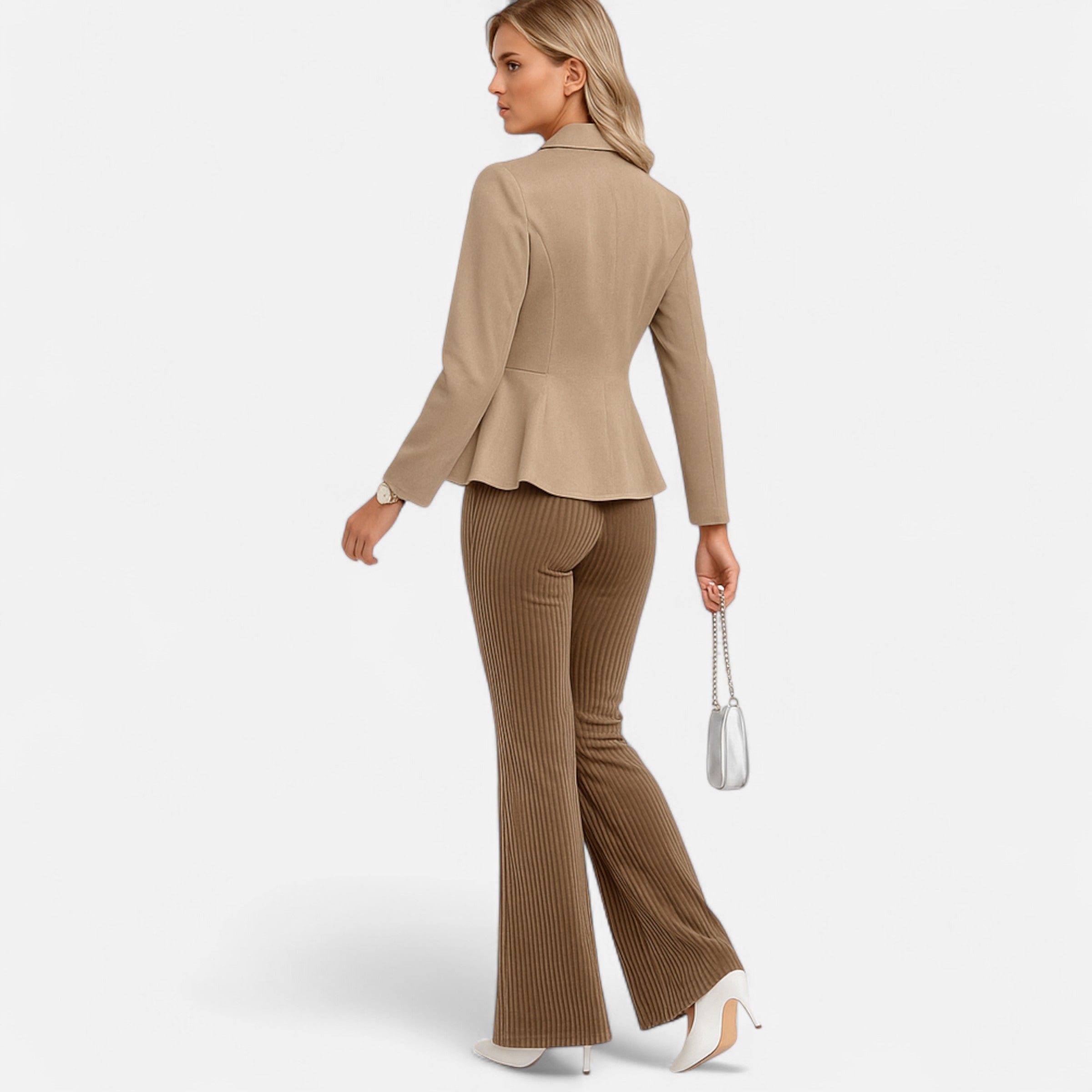 Woman wearing a beige suit with flared pants on a white background