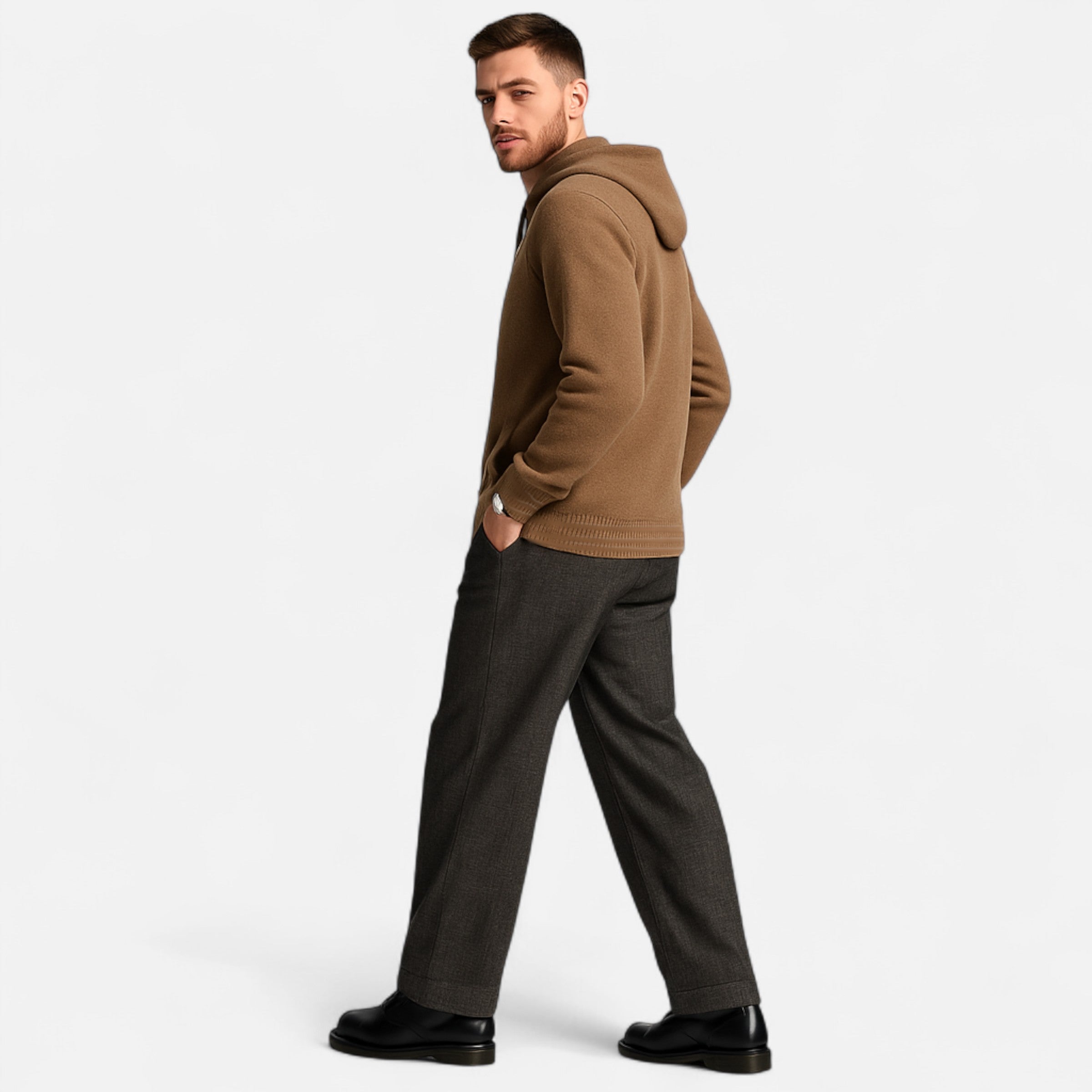 Man wearing a brown hoodie and gray pants on a white background