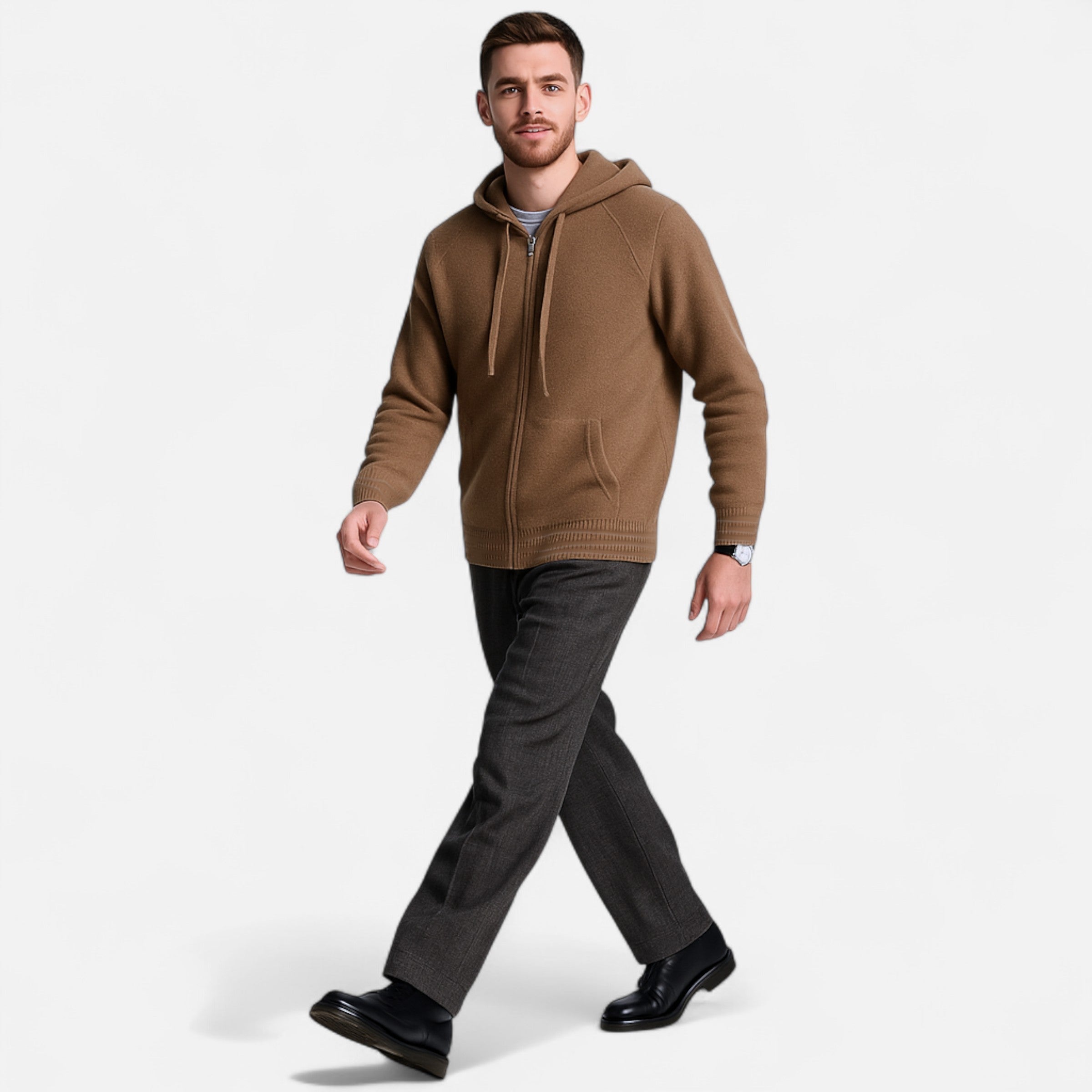 Man wearing a brown hoodie and black pants on a white background