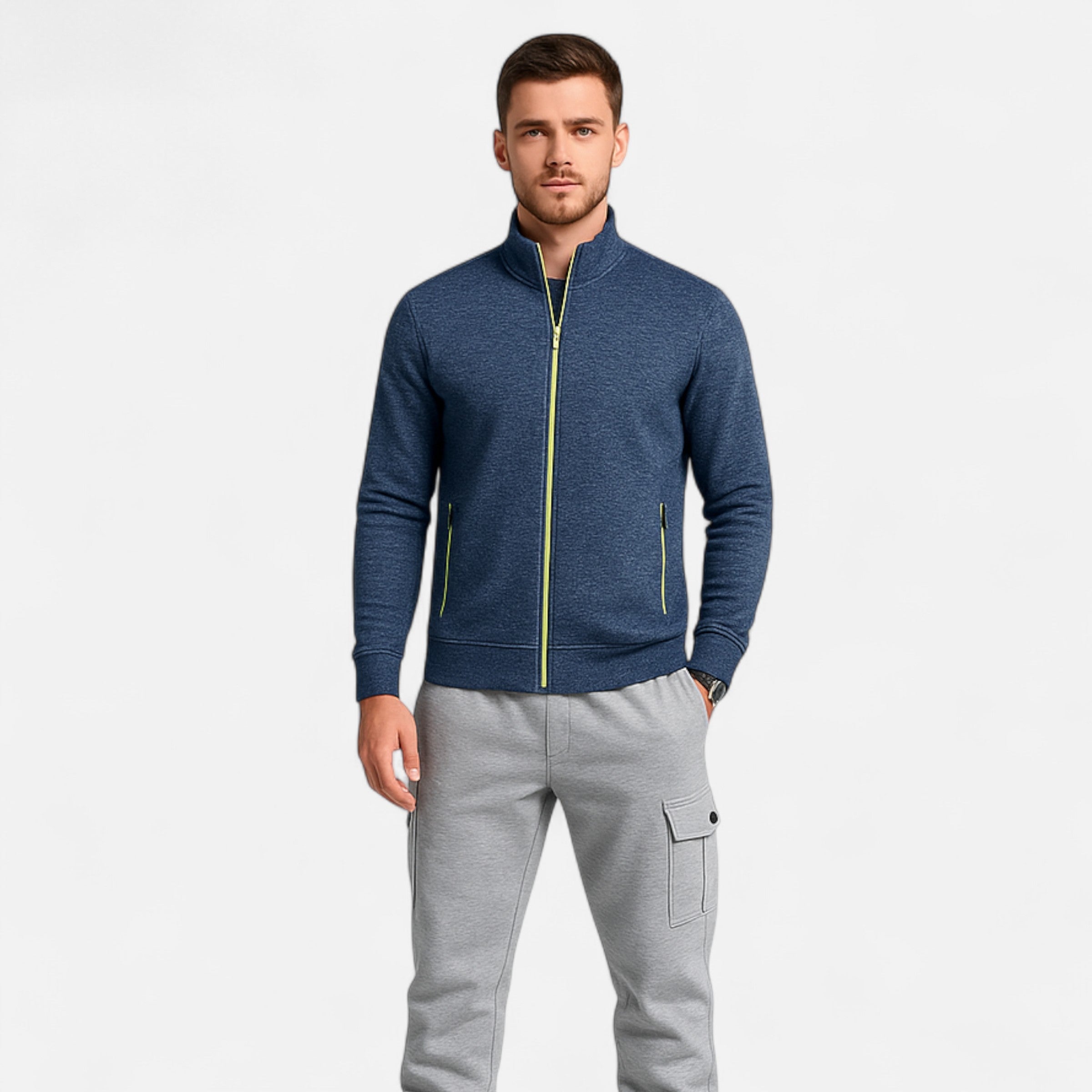 Man wearing a blue jacket with a zipper and gray pants on a white background