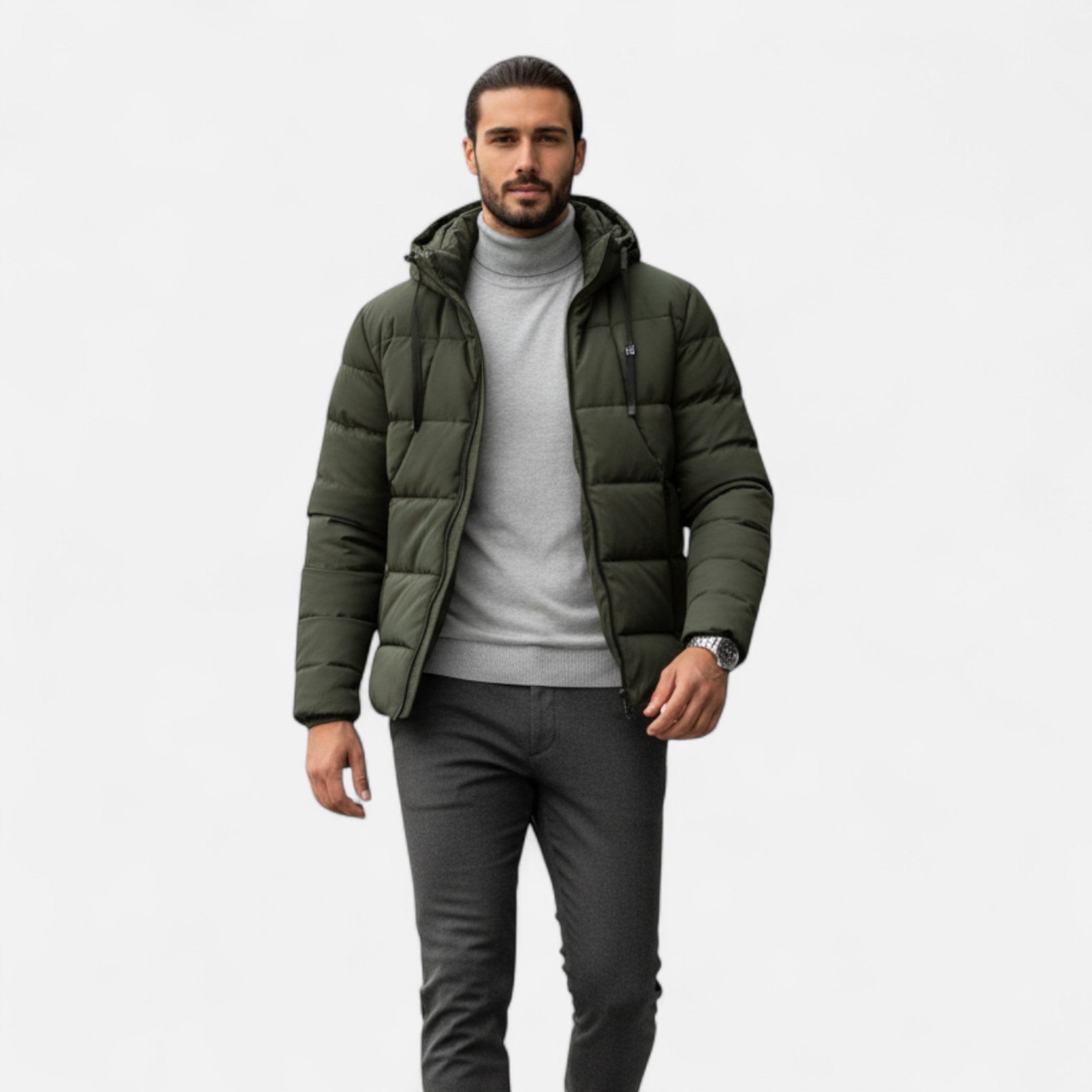 Man wearing a green puffer jacket on a white background