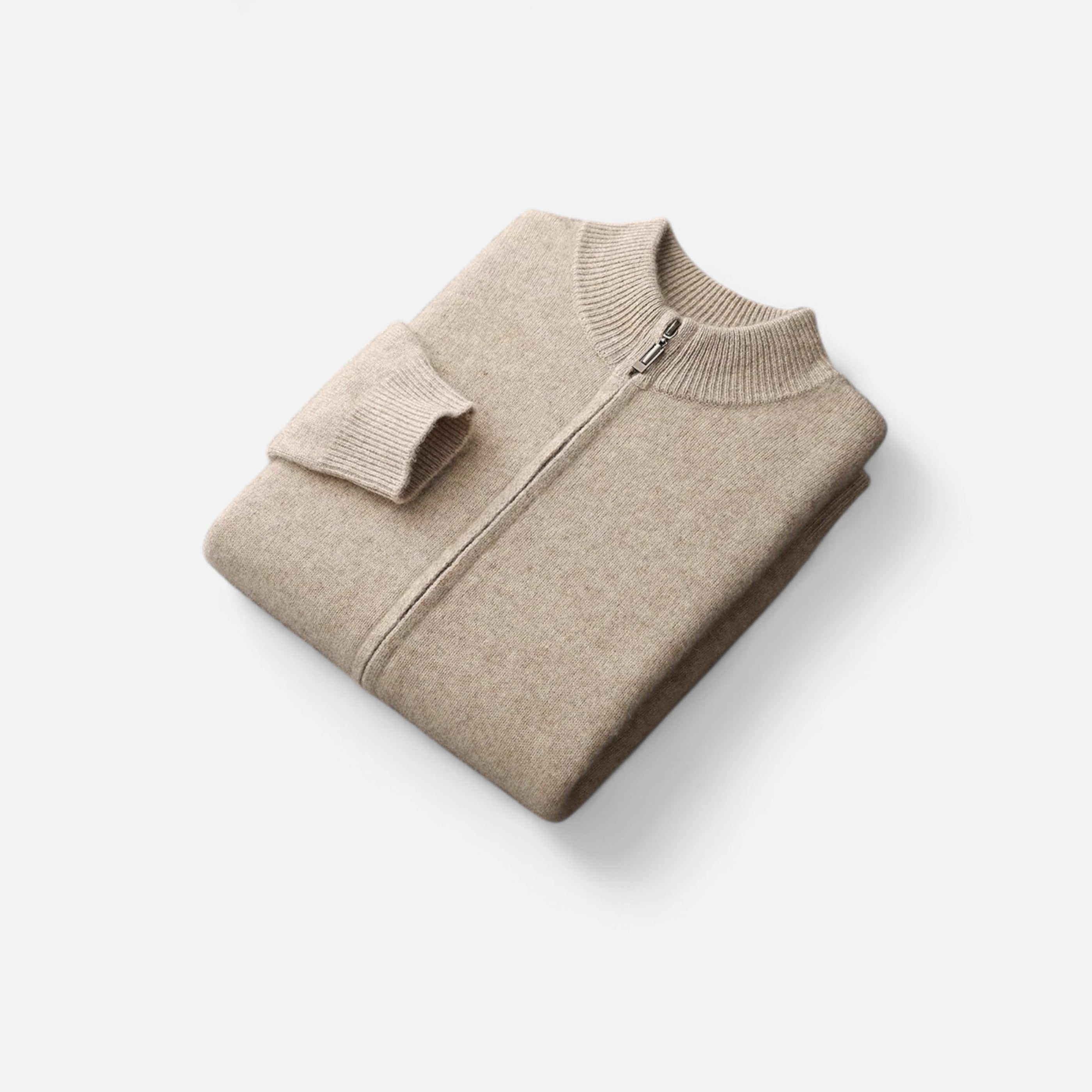 Folded beige sweater with a zipper on a white background